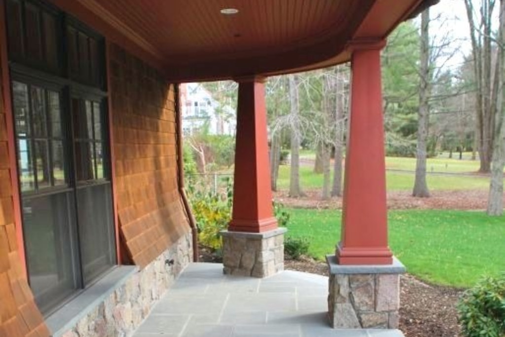 Front porch of shingle style home in NY by DeMotte Architects