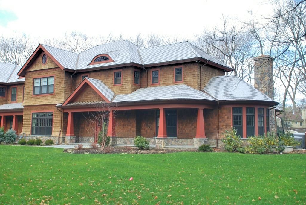 Home with cedar shingles, stone base, tapered bungalow columns