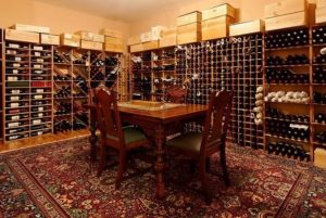 Traditional wine room in shingle style home in NY by DeMotte Architects
