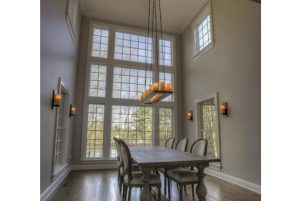 Beautiful dining room with large windows in NY home remodel by DeMotte Architects