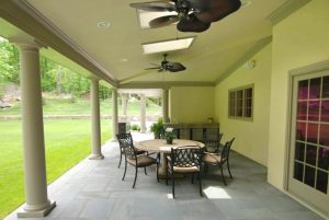Covered terrace with ceiling fans in CT custom home