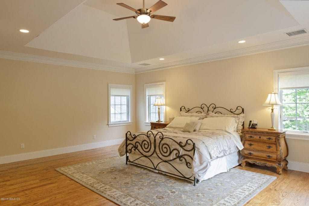 Master bedroom in Greenwich CT custom home by DeMotte Architects