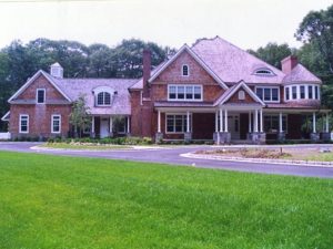 Shingle style home design by DeMotte Architects front of home shown in Pound Ridge NY