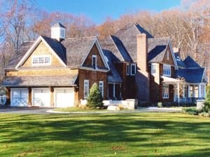 Shingle style home with 3 car garage home design by DeMotte Architects in NY