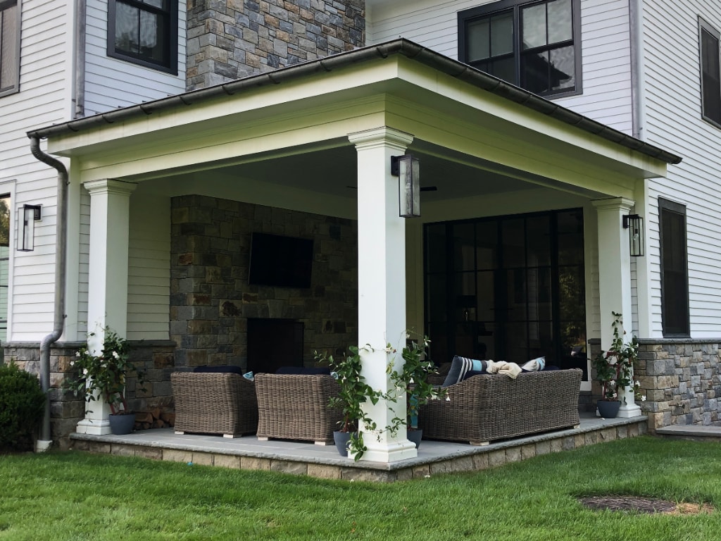 Modern farmhouse with outdoor fireplace by DeMotte Architects in CT